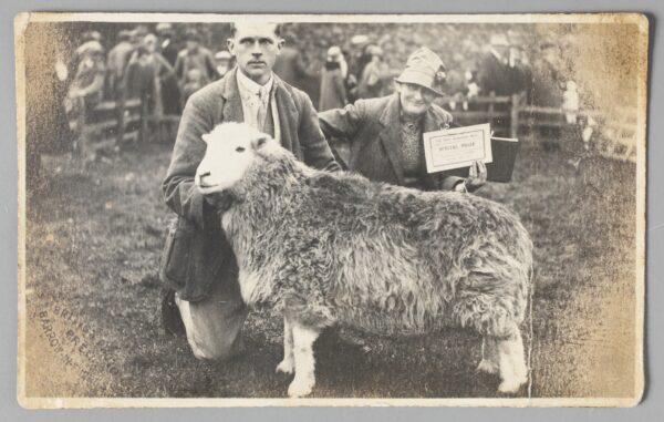 Tom Storey and Beatrix Heelis with prize-winning ewe, Sept. 26, 1930. Photographic print, published by the British Photo Press. (National Trust)