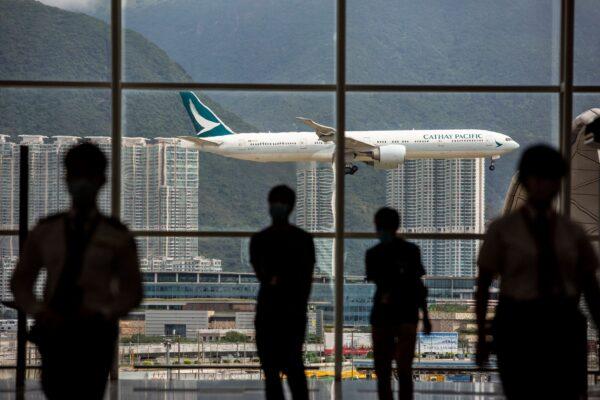 A Cathay Pacific aircraft comes into land at Hong Kong International Airport on Aug. 11, 2021. (Isaac Lawrence/AFP via Getty Images)