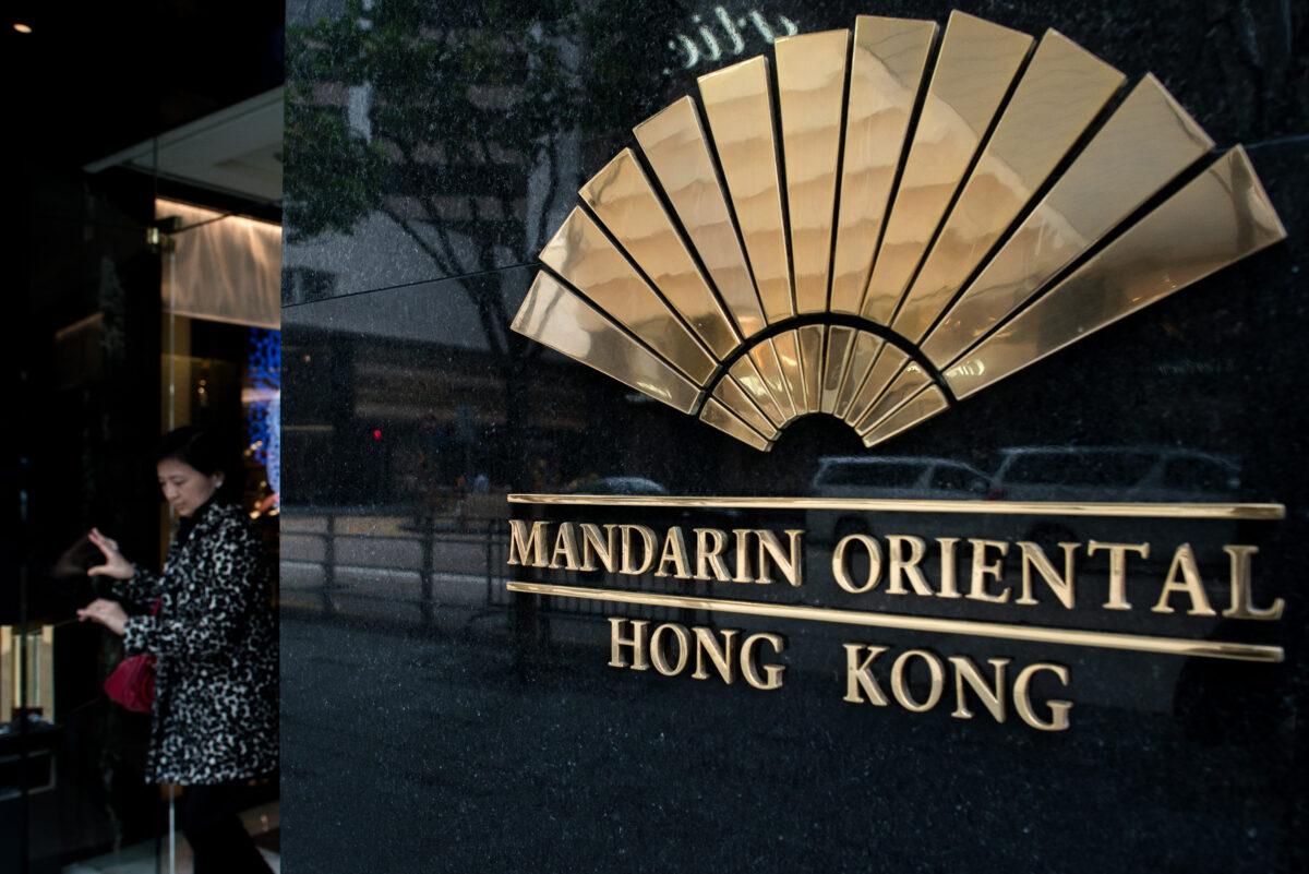 <br/>A woman walks out of the Mandarin Oriental hotel in Hong Kong on February 7, 2014. (Philippe Lopez/AFP via Getty Images)