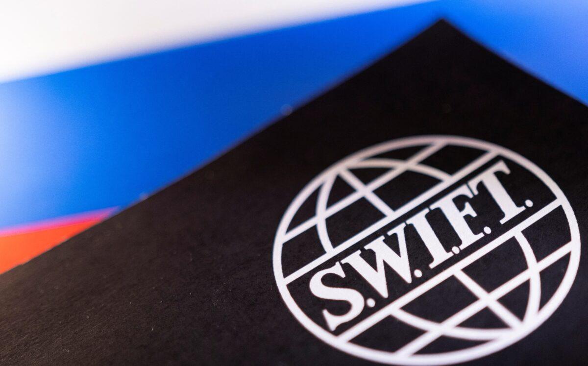 Swift logo is placed on a Russian flag in an illustration on Feb. 25, 2022. (Dado Ruvic/Reuters)