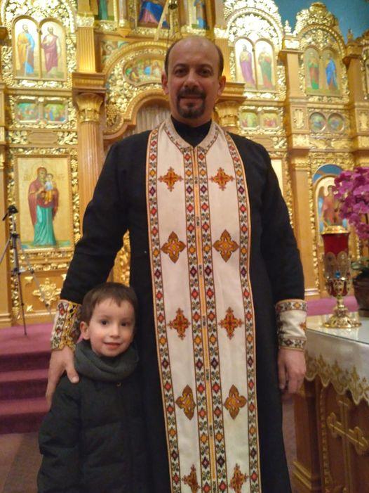The Rev. Michael Hontaruk of St. Vladimir Ukrainian Orthodox Cathedral in Parma, Ohio, on Feb. 25. Here Hontaruk is pictured in the cathedral with his son, Peter, 4. (Michael Sakal/The Epoch Times)