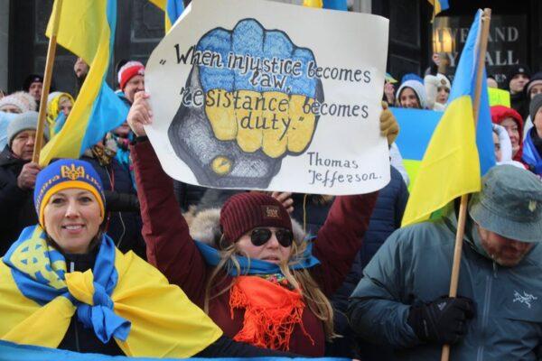 A woman holds up her sign during a rally in downtown Cleveland on Feb. 26, 2022, to show support for Ukraine. About 1,000 people turned out for a rally on Cleveland's Public Square after the earlier one on the steps of Cleveland City Hall. (Michael Sakal/The Epoch Times)