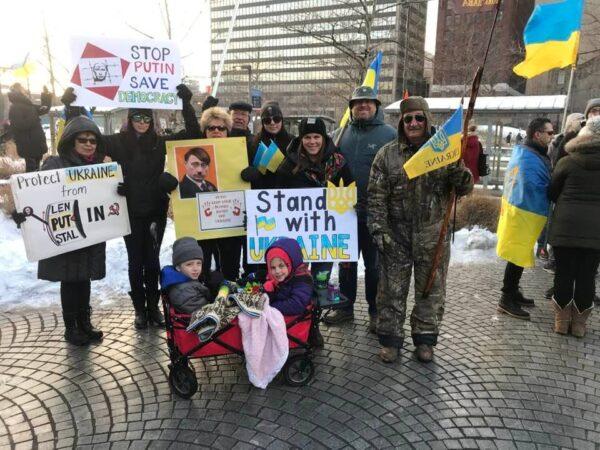 The families of Richard and Larissa Reidy, and Alex Pohuliaj, all of Lorain, Ohio, are active in northeast Ohio's Ukrainian community. They were among many families who turned out at rallies in Cleveland on Feb. 26 to show support for Ukraine. (Michael Sakal/The Epoch Times)