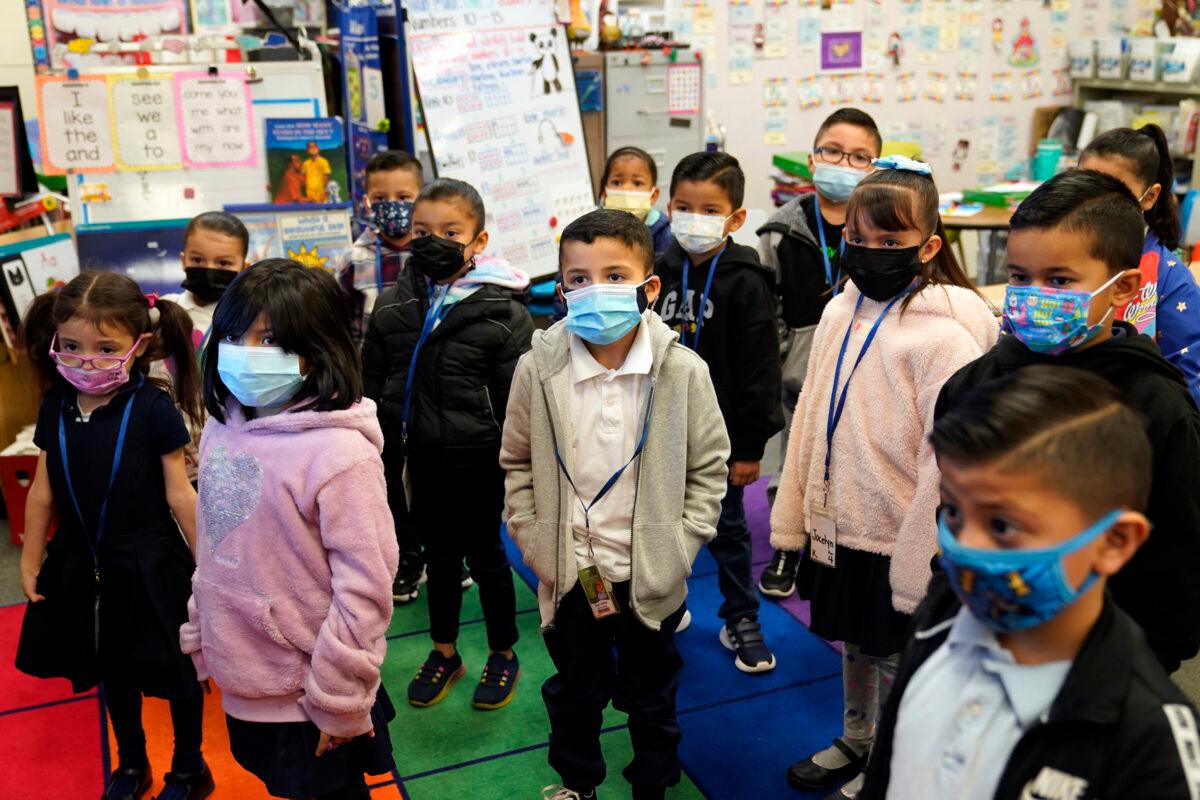 Kindergarteners wear masks while listening to their teacher at Washington Elementary School in Lynwood, Calif., on Jan. 12, 2022. (Marcio Jose Sanchez/AP Photo)