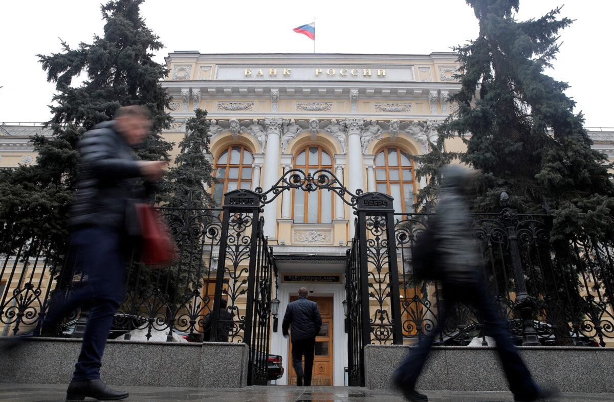 People walk past the Central Bank headquarters in Moscow on Feb. 11, 2019. (Maxim Shemetov/Reuters)