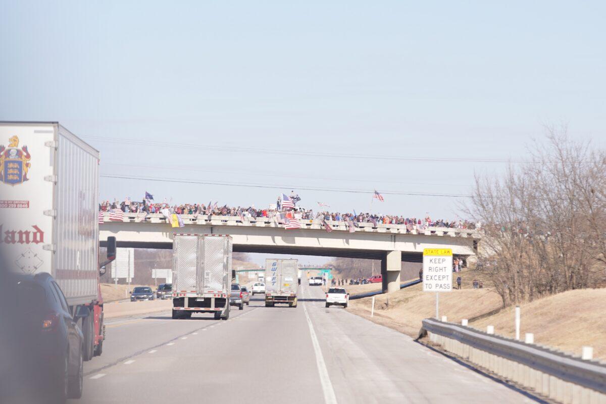 Truckers that are part of The People's Convoy drive past an overpass with supporters in Oklahoma on Feb. 27, 2022. (Enrico Trigoso/The Epoch Times)
