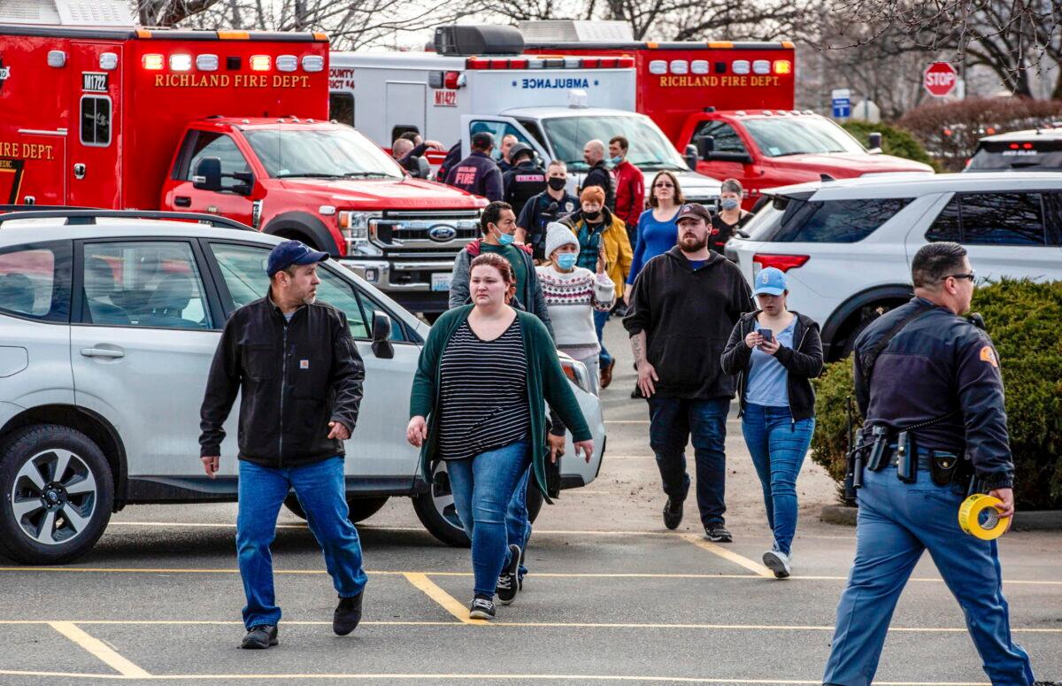 Customers and employees are guided out of a Fred Meyer grocery store after a fatal shooting at the business on Wellsian Way in Richland, Wash., on Feb. 7, 2022. (Jennifer King/The News Tribune via AP)