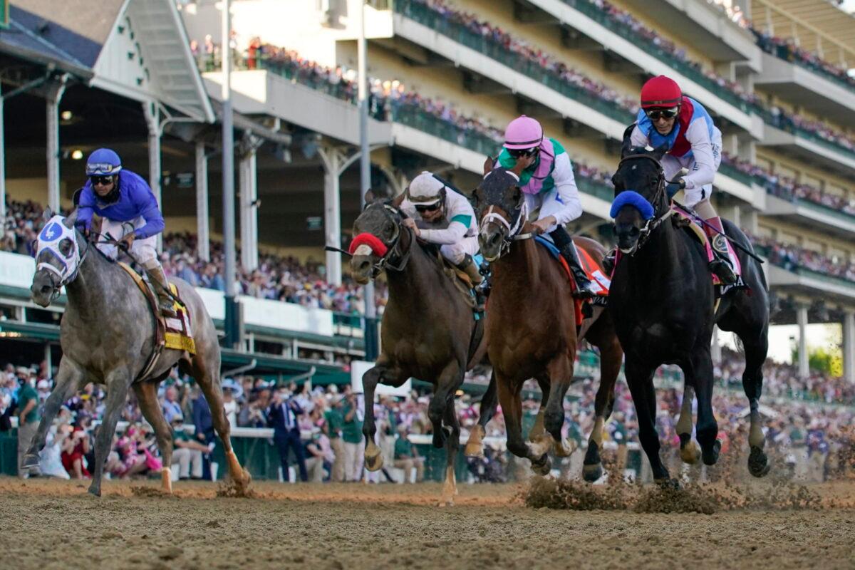 John Velazquez riding Medina Spirit (R) leads Florent Geroux on Mandaloun, Flavien Prat riding Hot Rod Charlie, and Luis Saez on Essential Quality to win the 147th running of the Kentucky Derby at Churchill Downs in Louisville, Ky., on May 1, 2021. (Jeff Roberson/AP Photo)