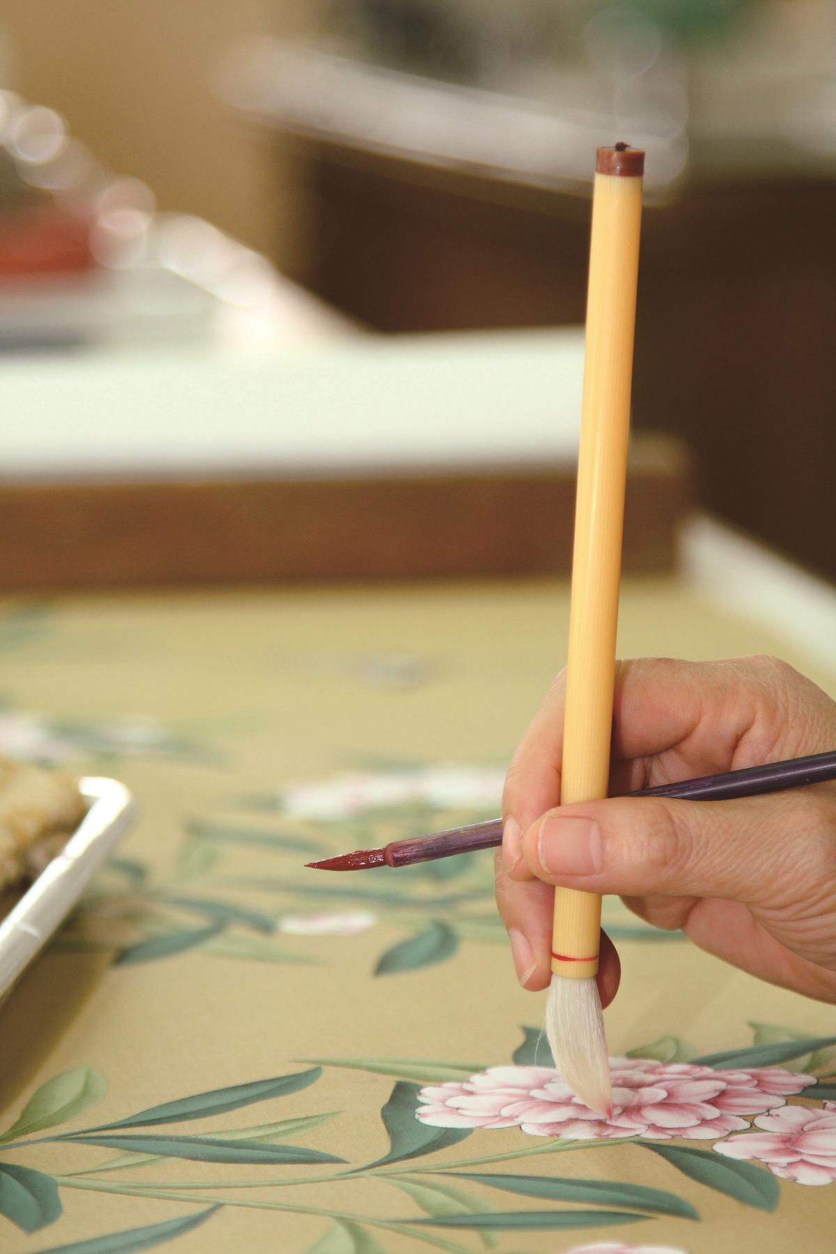 The intricate details and fine line work of hand-painted Chinoiserie wallcoverings are produced by highly skilled artists. It's a labor-intensive procedure. Every studio is slightly different. For Gracie Studio, each panel requires about 75 to 100 hours of artwork. (Courtesy of Gracie Studio)