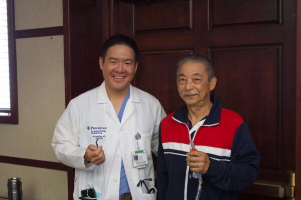 Manh Nguyen (R) and his cardiologist Dr. Michael Chan pose for a photo in Orange, Calif., on March 31, 2022. (Drew Van Voorhis/The Epoch Times)