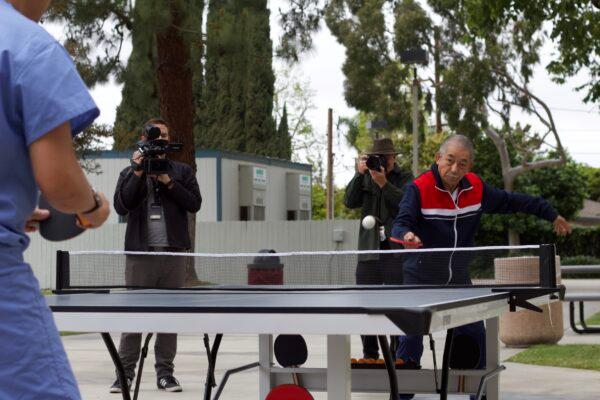 Manh Nguyen plays ping pong with his cardiologist Dr. Michael Chan in Orange, Calif., on March 31, 2022. (Drew Van Voorhis/The Epoch Times)