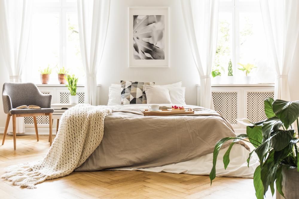 Swap out heavy, luxe drapes for lighter, fresher fabrics, such as linen or cotton. (Photographee.eu/Shutterstock)