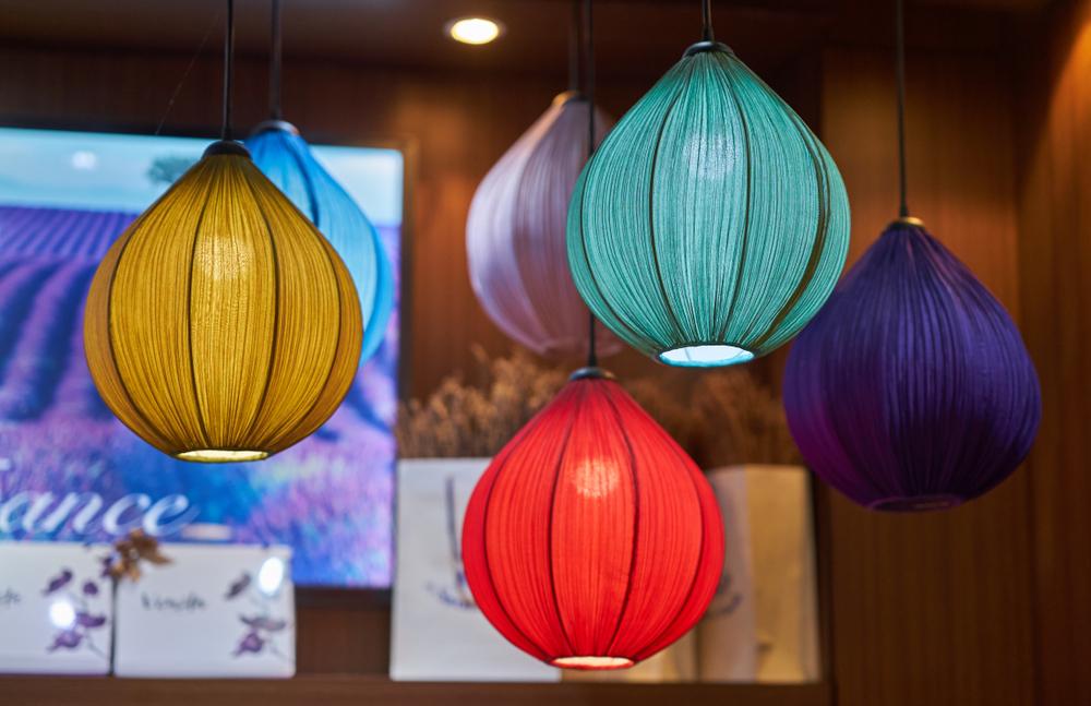 Switching out a plain lampshade for a bright one is an easy way to add a jolt of refreshing spring color. (John And Penny/Shutterstock)