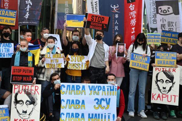 People hold placards during a protest against Russia's invasion of Ukraine, outside the Russian representative office in Taipei, Taiwan, on March 1, 2022. (Sam Yeh/AFP via Getty Images)
