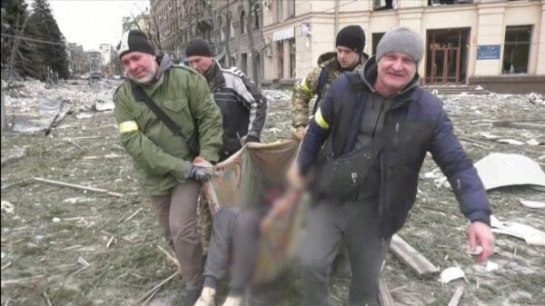 Medics seen carrying dead bodies after rocket attack in Kharkiv, Ukraine on March 1, 2022. (Reuters/Screenshot via The Epoch Times)