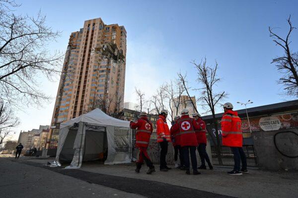 Medics gather by a high-rise apartment block that was hit by recent shelling in Kyiv, Ukraine, on Feb. 26, 2022. (Genya Savilov/AFP via Getty Images)