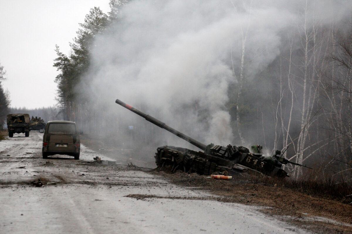 Smoke rises from a Russian tank destroyed by the Ukrainian forces on the side of a road in Lugansk region, Ukraine on Feb. 26, 2022. (ANATOLII STEPANOV/AFP via Getty Images)