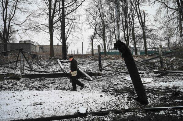 An elderly man passes by wreckage of a building after reported shelling in Kyiv, Ukraine, on March 2, 2022. (Aris Messinis/AFP via Getty Images)