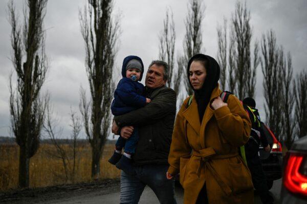 A family fleeing the conflict in Ukraine walks after crossing the Moldova-Ukraine border checkpoint near the town of Palanca, Moldova on March 2, 2022. (Nikolay Doychinov/AFP via Getty Images)