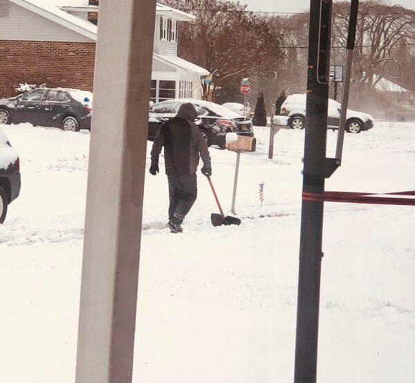 Brian Dignen shovels the snow in his neighborhood. (Courtesy of <a href="https://www.facebook.com/mommydignen">Holly Dignen</a>)