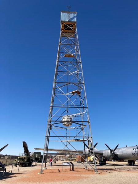 A replica of the atomic bomb tower that was used at the Trinity test site on July 16, 1945, stands at The National Museum of Nuclear Science and History in Albuquerque, N.M., on Feb. 26, 2022. (Below), a close-up view of a model of the bomb. (Allan Stein/The Epoch Times)