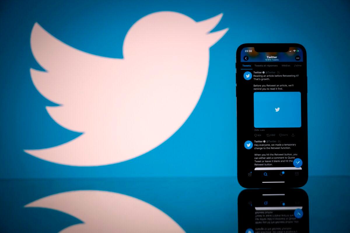 The Twitter logo is displayed on the screen of a smartphone and a tablet in Toulouse, southern France on Oct. 26, 2020. (Lionel Bonaventure/AFP via Getty Images)