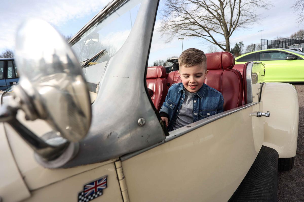Classic and sports car enthusiasts turned up to celebrate a special birthday for a boy with autism. (SWNS)