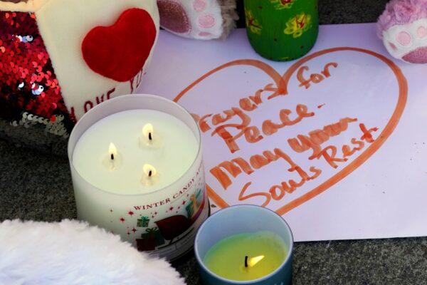 Candles and a note are part of a memorial left for the three young girls who were slain by their father at the Church in Sacramento, Calif., on March 1, 2022. (Rich Pedroncelli/AP Photo)