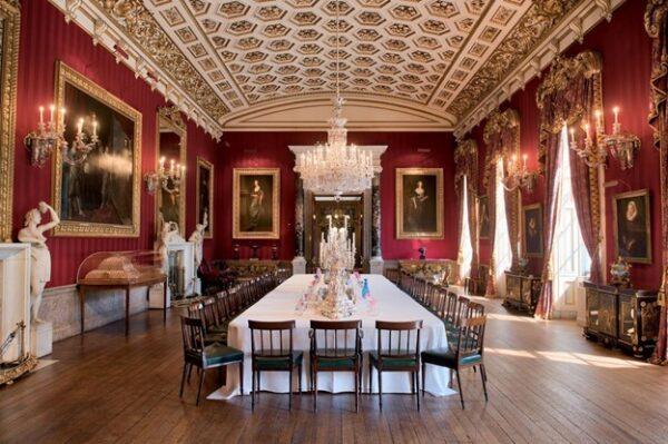 The north wing was the setting for many country-house parties. With the hexagonal coffered ceiling above, and candelabras, sculptures, and portraits presented on the walls, the Grand Dining Room would host elaborate formal dinners. (Chatsworth House Trust)