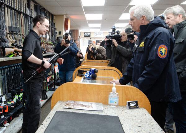 Nassau County Executive Bruce Blakeman makes a purchase of a Zastava M-70, assault rifle to be donated in his guns-for-Ukraine initiative at SP Firearms in Franklin Square, NY, on March 3, 2022. (Dave Paone/The Epoch Times)