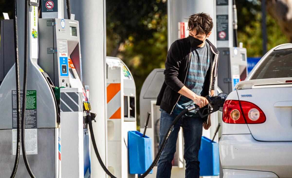 Gas stations serve customers at peak prices in Irvine, Calif., on Feb. 23, 2022. (John Fredricks/The Epoch Times)