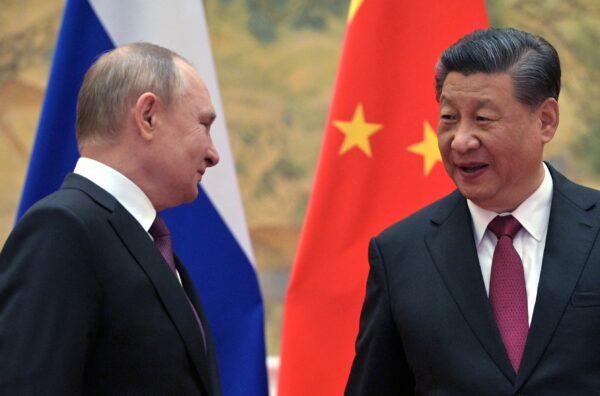 Russian President Vladimir Putin and Chinese leader Xi Jinping arrive to pose for a photograph during their meeting in Beijing, on Feb. 4, 2022. (Alexei Druzhinin/Sputnik/AFP via Getty Images)