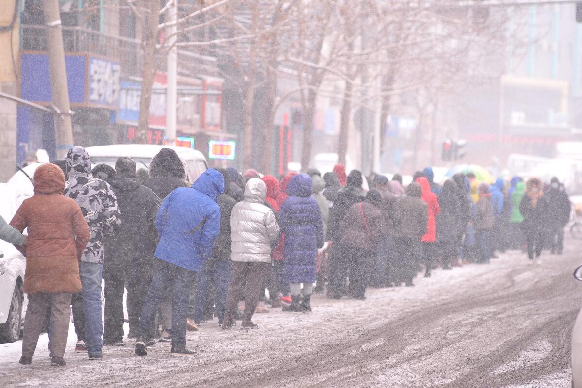 People are queueing to undergo nucleic acid tests for the COVID-19 as it snows in Harbin, in China's northeastern Heilongjiang Province, on March 2, 2022. (STR/AFP via Getty Images)