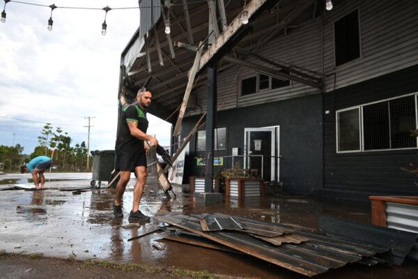 A man removes debris from his flood-affected car mechanic business in Lismore, Australia, on March 2, 2022. (Dan Peled/Getty Images)