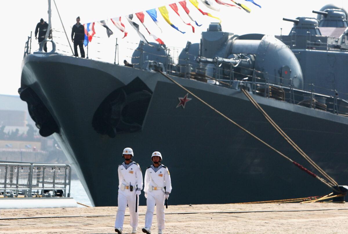 Chinese naval soldiers guard Russian missile cruiser Varyag docked at Qingdao Port on April 21, 2009 in Qingdao of Shandong Province, China. (Guang Niu/Pool/Getty Images)