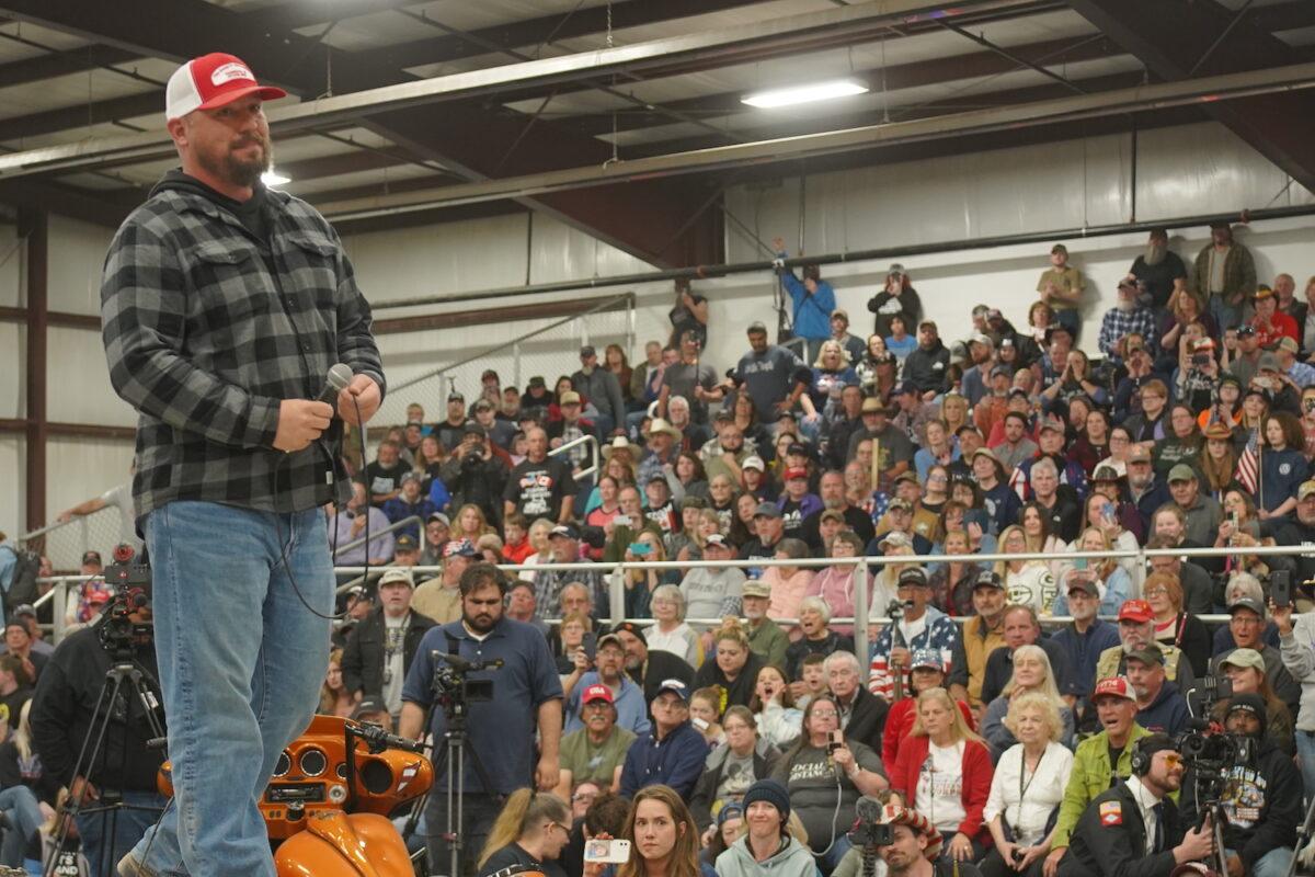 Brian Brase, an organizer of the People's Convoy, speaks on stage at a rally at Ted Everett Farm Center in Monrovia, Ind., on March 2, 2022. (Enrico Trigoso/The Epoch Times)