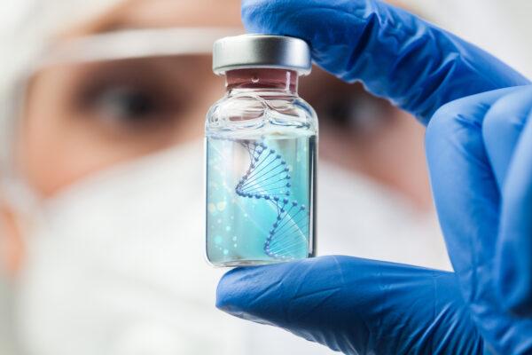 A researcher holds up a vile of DNA. (By Cryptographer/Shutterstock