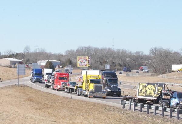 Trucks proceed on the road as part of the People's Convoy in St. Claire, Missouri, on March 1, 2022. (Enrico Trigoso/The Epoch Times)