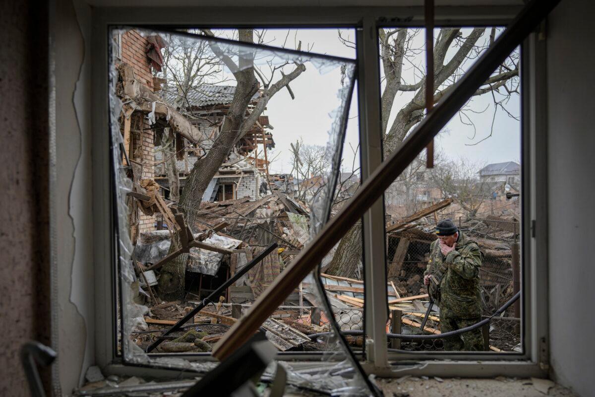  Andrey Goncharuk, 68, a member of territorial defense wipes his face in the backyard of a house that was damaged by a Russian airstrike, according to locals, in Gorenka, outside the capital Kyiv, Ukraine on March 2, 2022. (Vadim Ghirda/AP Photo)