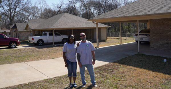 PATH's Nikki Pennington and Todd Straley stand in front of two homes renting for $650 a month to low-income families in the two-year Transitional Housing Program in Tyler, Texas, on March 3, 2022. (Patrick Butler/The Epoch Times)