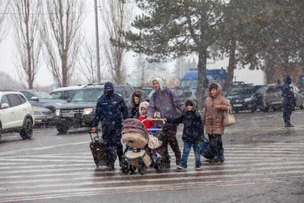 A Ukrainian family makes their way to the border between Ukraine and Romania in an effort to escape the city after the war began on Feb. 16, 2022. (Courtesy of James Judge, Project Dynamo)