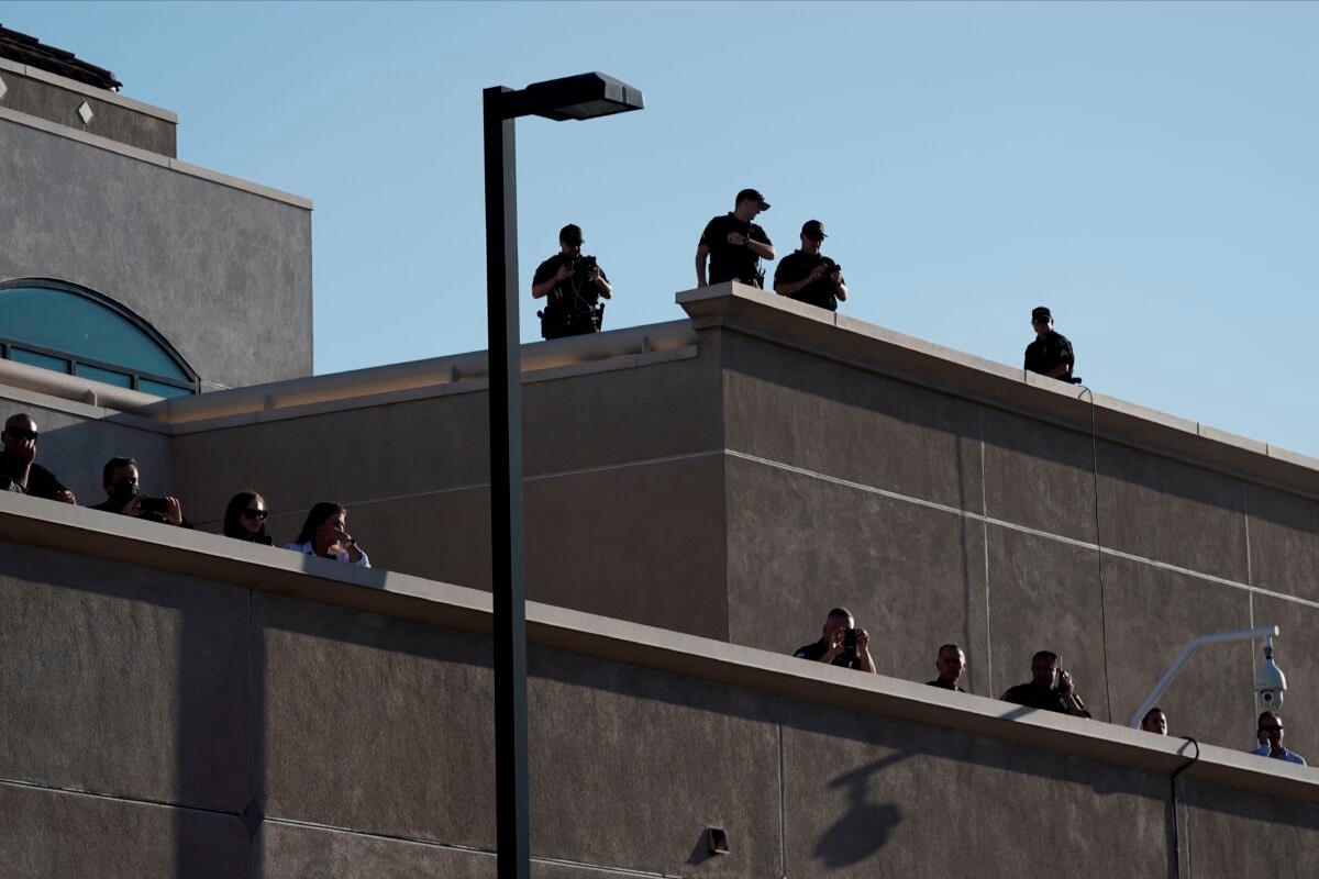 Police officers and unidentified observers watch a Black Lives Matter protest in La Mesa, Calif., on Aug. 1, 2020. (Bing Guan/AFP via Getty Images)