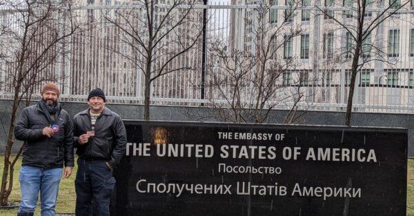 Bryan Stern, co-founder of Project Dynamo, stands with a friend in front of the sign for the now-shuttered American embassy in Kyiv, Ukraine, on Feb. 16, 2022. (Courtesy of James Judge, Project Dynamo)