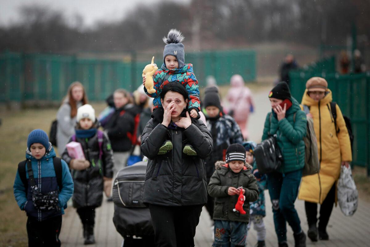 Refugees, mostly women with children, arrive at the border crossing in Medyka, Poland, on March 5, 2022. (Visar Kryeziu/AP Photo)