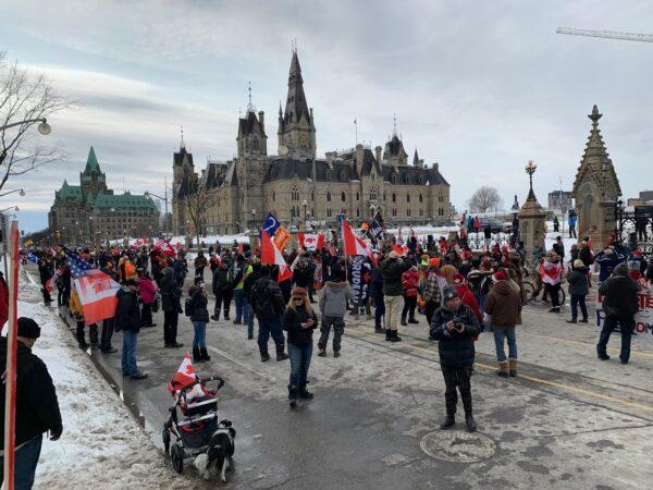 Demonstrators protesting against COVID-19 mandates and restrictions gather in front of the Parliament Buildings in Ottawa on March 5, 2022. (Jonathan Ren/The Epoch Times)