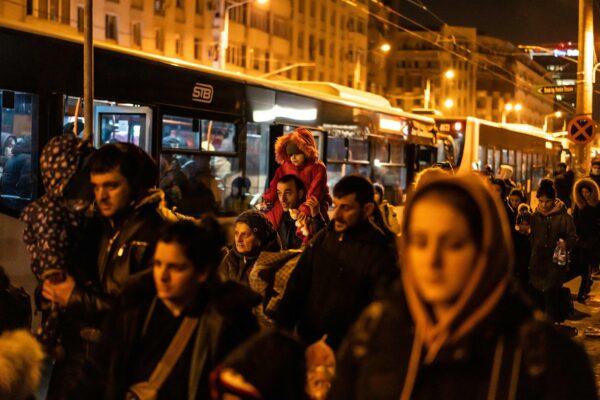 Refugees from Ukraine board buses after arriving at the North Railway Station in Bucharest, Romania on March 4, 2022. (Mihai Barbu/AFP via Getty Images)