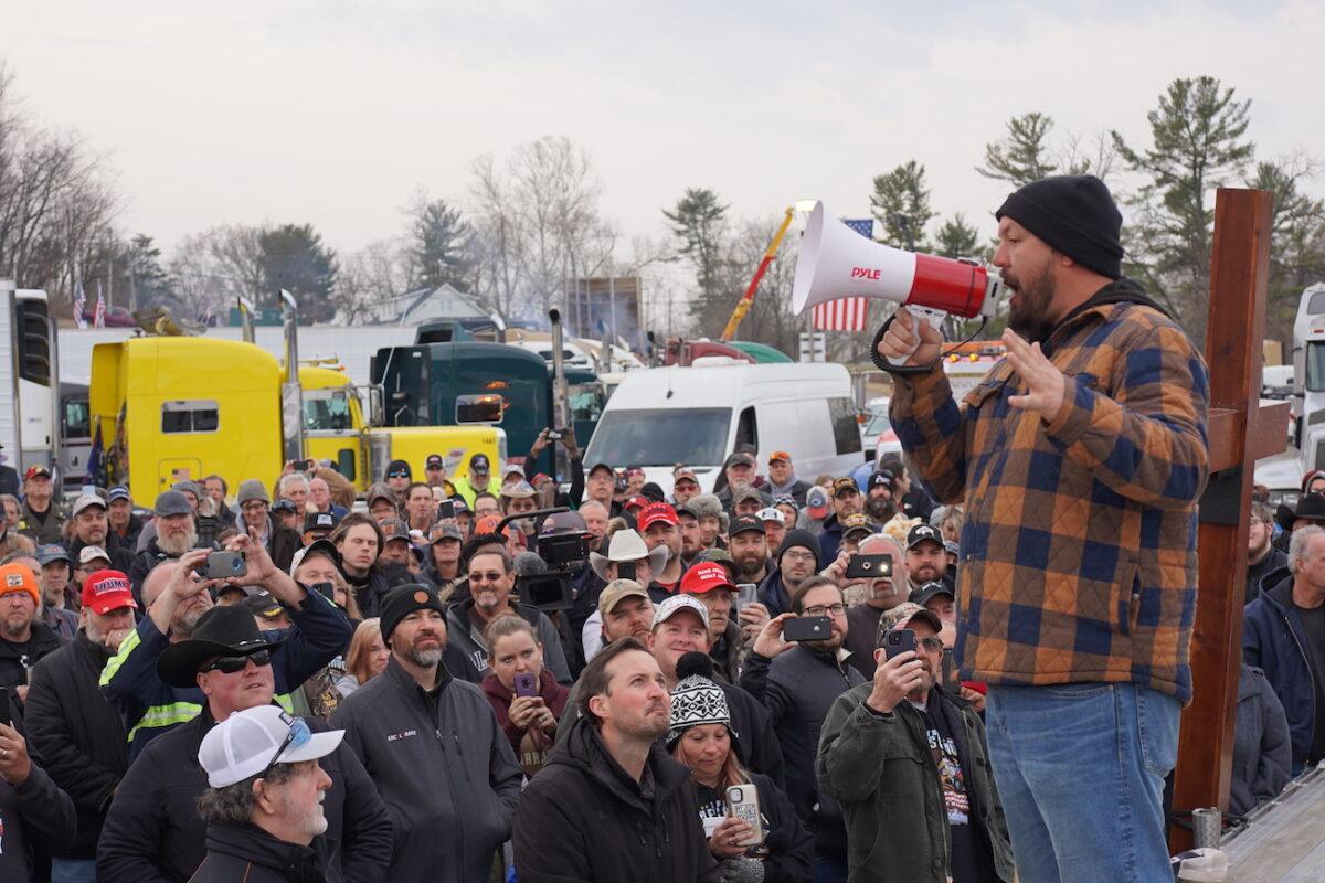 Brian Brase, a truck driver from Ohio and a co-organizer of The People's Convoy, speaks to drivers at Hagerstown Speedway, in Hagerstown, Md., on March 5, 2022. (Enrico Trigoso/The Epoch Times)