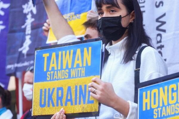 A demonstrator holds a placard during a rally against Russia's invasion of Ukraine outside a Moscow representative office in Taipei, Taiwan, on March 1, 2022. (Ann Wang/Reuters)