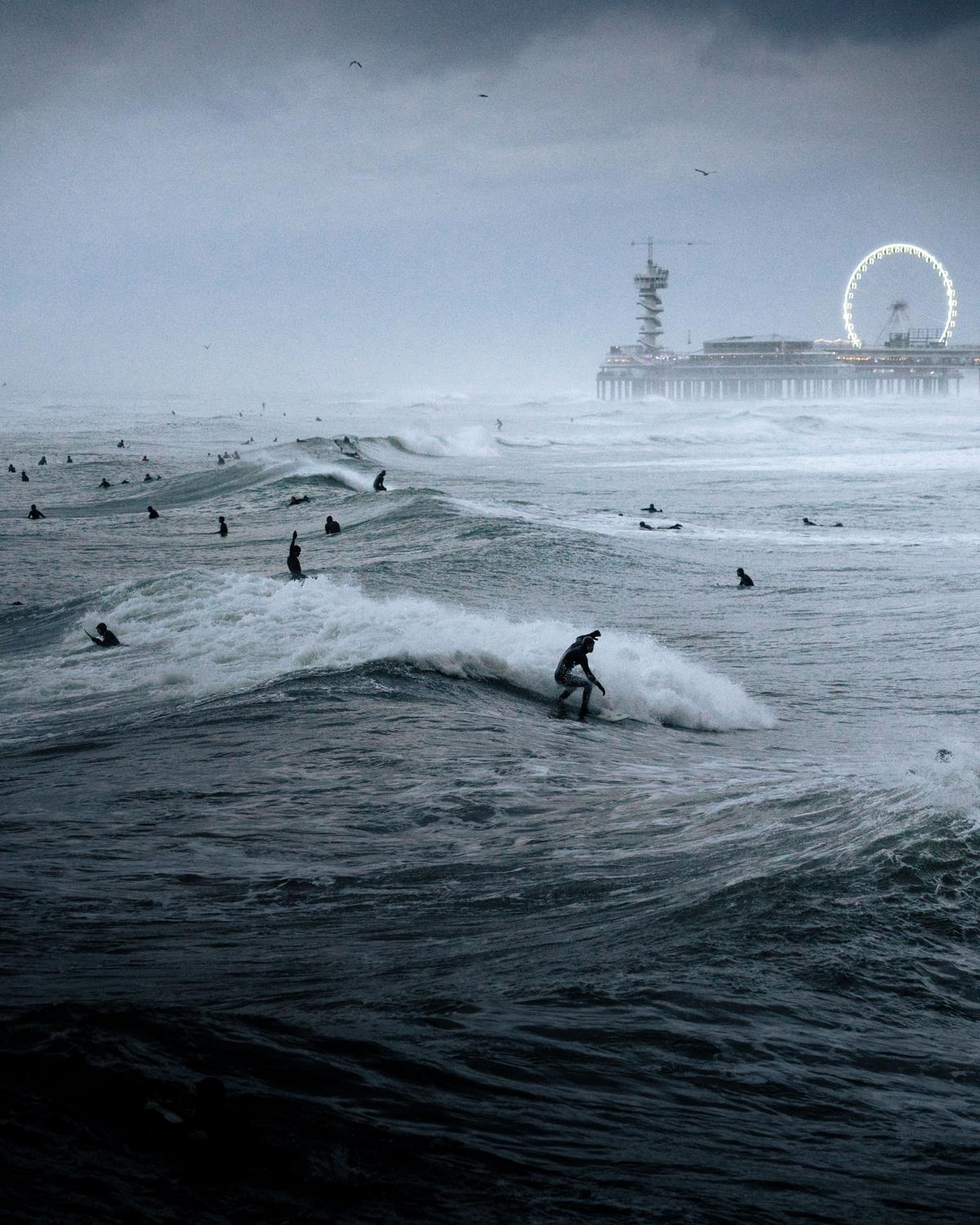 "Surfing Festival" by Raido Nurk, Estonia; "The waves were the biggest I’ve ever seen in the evening when I took this photo in The Hague, Netherlands. The waves and the pouring rain created quite a unique atmosphere." (© Raido Nurk, Estonia, Winner, National Awards, Motion, 2022 Sony World Photography Awards)