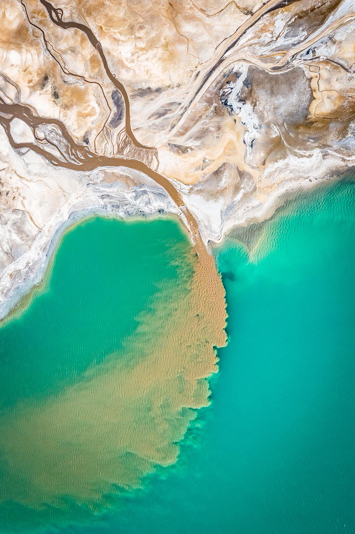 "Turquoise Lake" by Marcin Giba, Poland; "I took this photo of a turquoise lake in Poland with a drone in autumn 2021. Let us not be deceived by the blue color of the water, or the color of the sand. It is the result of human activity interfering with the natural environment. You cannot bathe in this lake, and the water is poisonous." (© Marcin Giba, Poland, Winner, National Awards, Landscape, 2022 Sony World Photography Awards)
